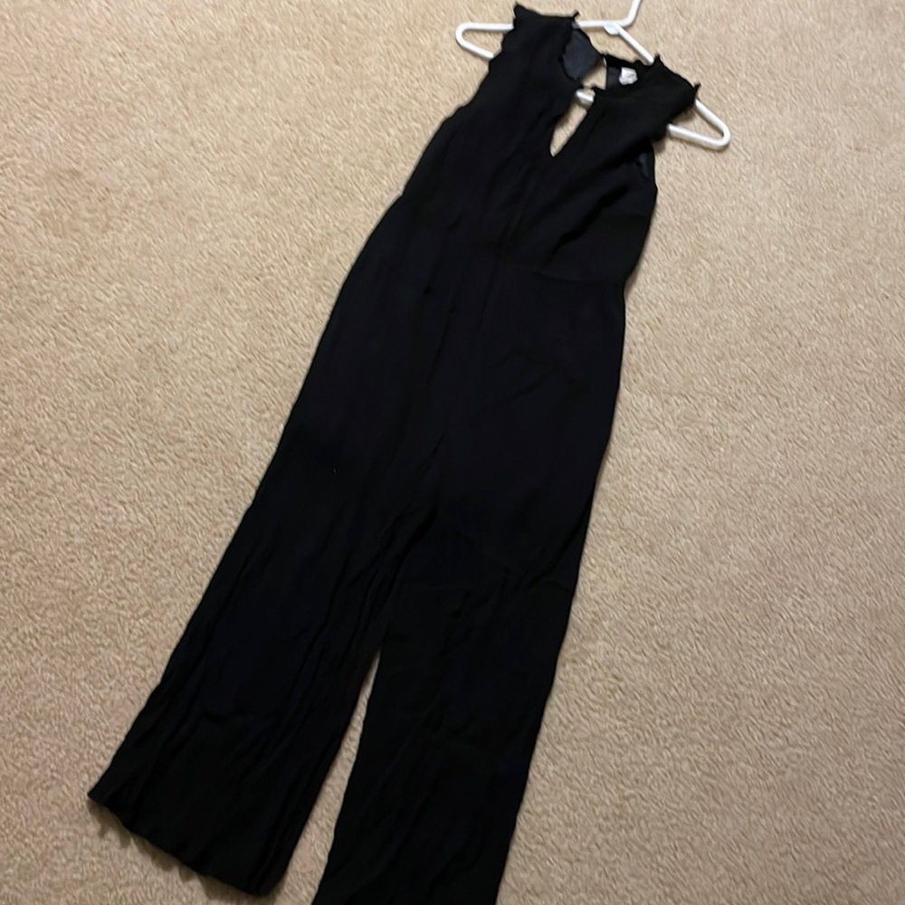 Sienna Sky Black jumpsuit Size L. Sleeveless button at neck.